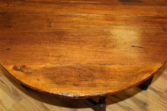 An 18th century walnut oval gateleg dining table, extended 4ft 9in.